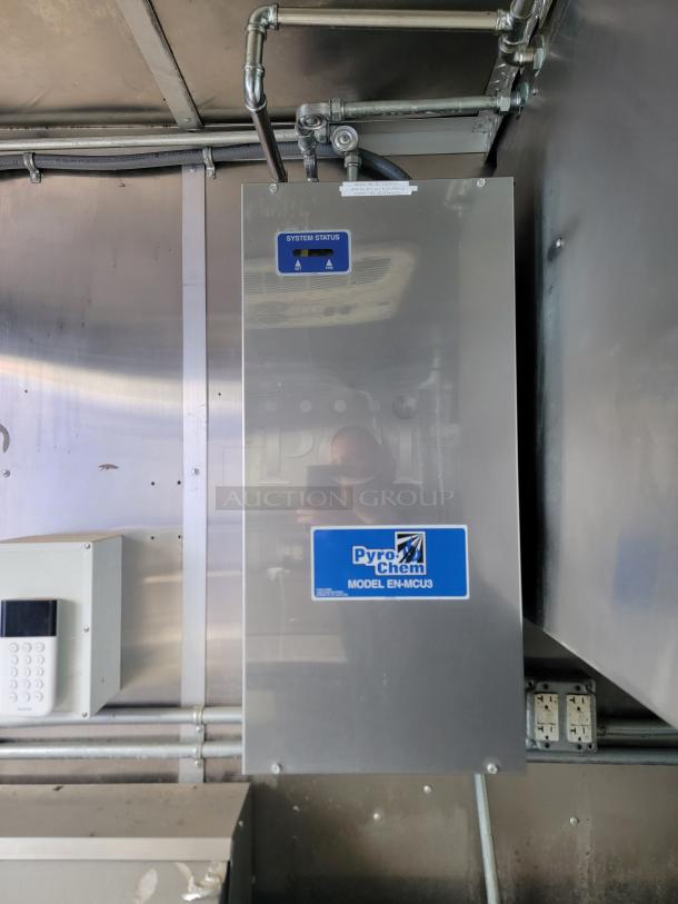 PyroChem Model EN-MCU3 control panel inside 2020 Diamond Cargo mobile kitchen, showing system status display.