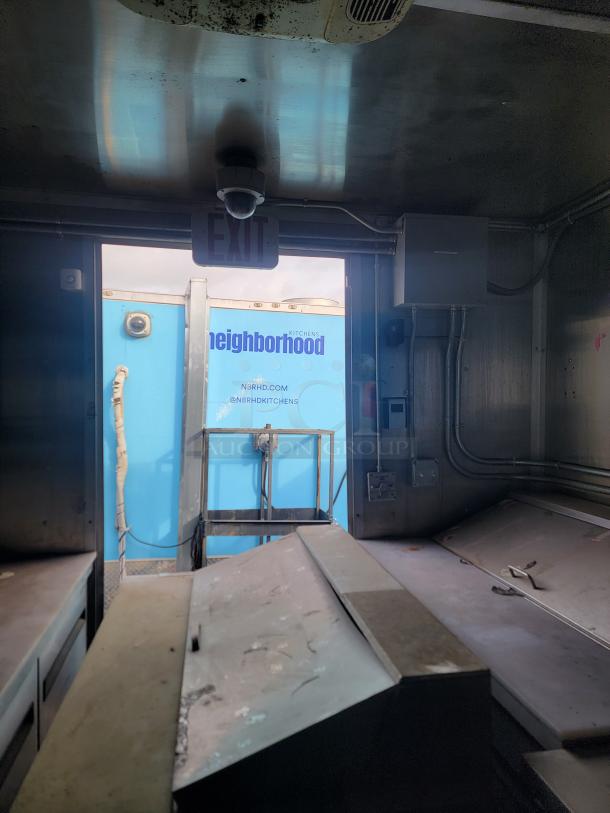 Interior view of a 2020 24' Diamond Cargo mobile kitchen, featuring commercial equipment and visible wear. Needs cleaning.