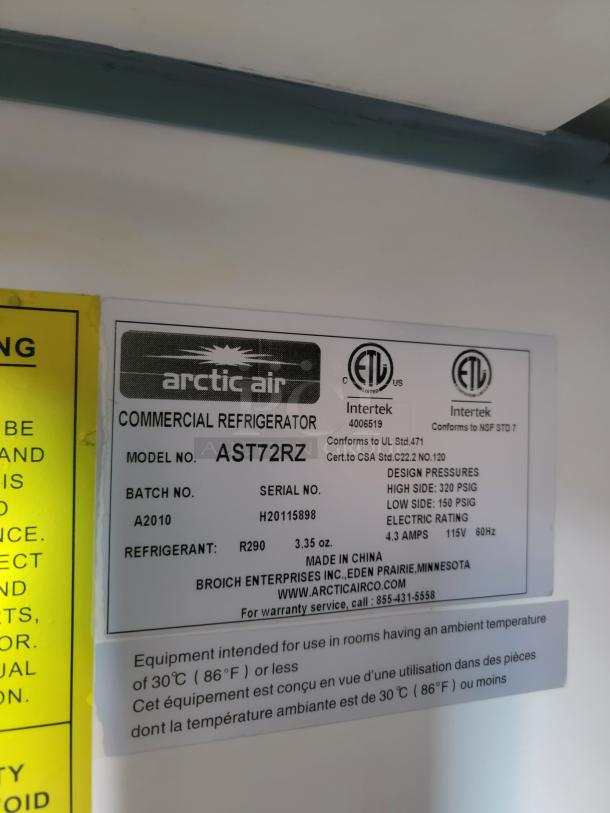 Arctic Air commercial refrigerator label showing model AST72RZ, batch A2010, serial H20115898, and refrigerant R290 details.