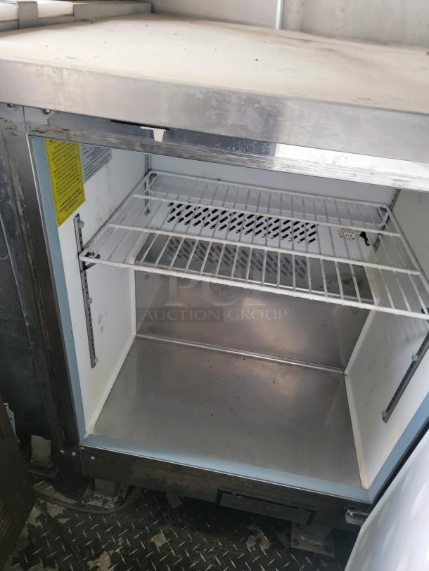 Open Arctic Air freezer inside 2020 Diamond Cargo mobile kitchen. Visible dust and grime indicate need for cleaning.