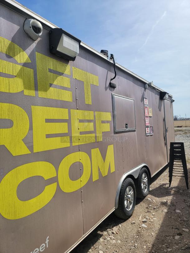 2019 Diamond Cargo 24' food trailer with stainless steel walls, ventilation hood, and Arctic Air refrigeration; needs deep cleaning.