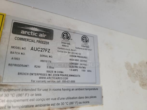 Arctic Air commercial freezer label showing model AUC27FZ, serial H9010176, design pressures, and electrical rating.