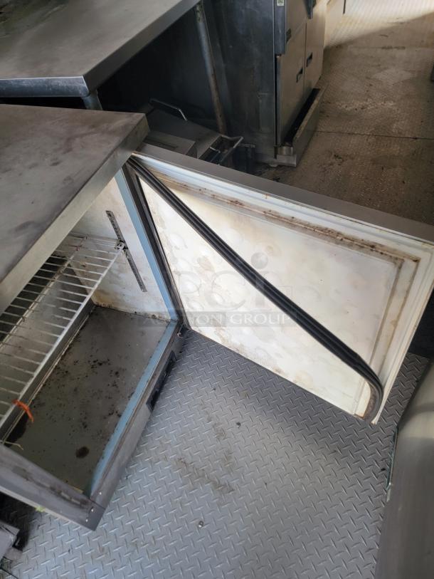 2019 Diamond Cargo food trailer interior, showing open Arctic Air refrigeration unit and stainless steel surfaces, needing cleaning.