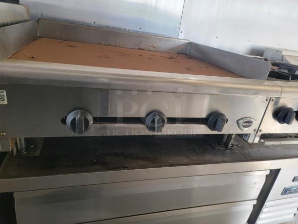 2019 Diamond Cargo food trailer interior with Wells griddle, stainless steel surfaces, and Arctic Air refrigeration. Needs cleaning.
