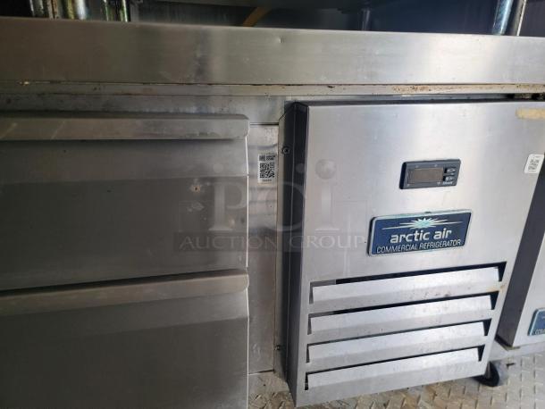 2019 Diamond Cargo 24' food trailer detail showing Arctic Air commercial refrigerator, stainless steel surface; needs cleaning.