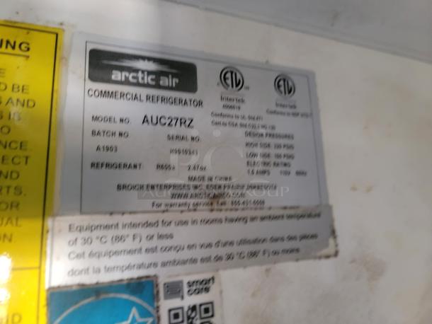 Arctic Air Commercial Refrigerator label, model AUC27RZ. Shows serial number, refrigerant type, and usage specifications.