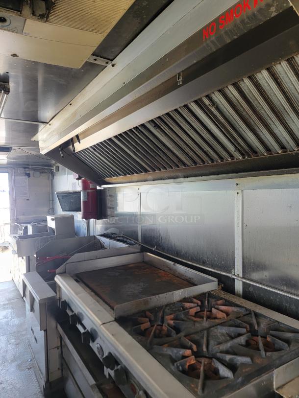 2019 24' Diamond Cargo kitchen trailer with Arctic Air fridge, dual fryers, griddle, and exhaust hood. Needs cleaning.