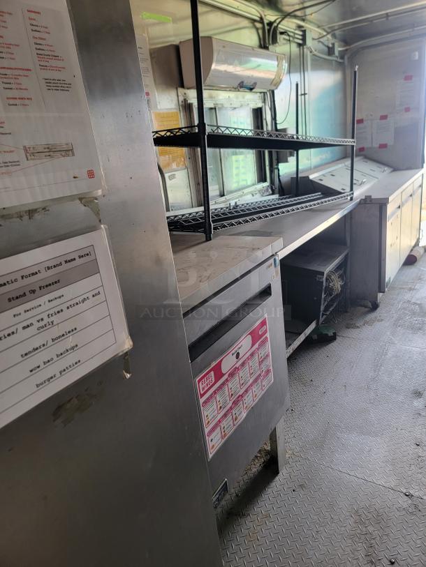 2019 Diamond Cargo 8.5x24 mobile kitchen interior, features Arctic Air refrigeration, fryers, griddle, stainless hood. Needs cleaning.