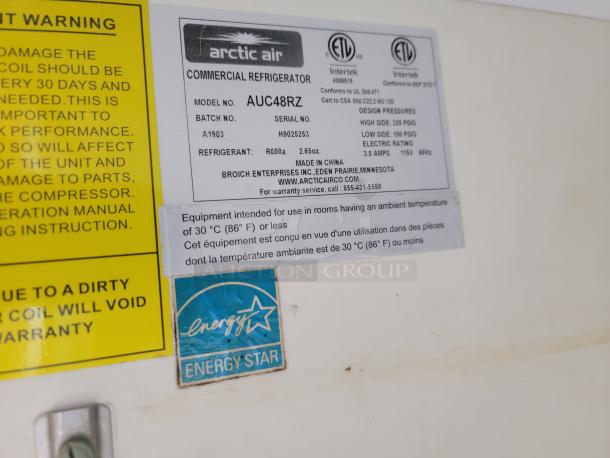 Arctic Air commercial refrigerator label, model AUC48RZ, with Energy Star certification and usage warnings.
