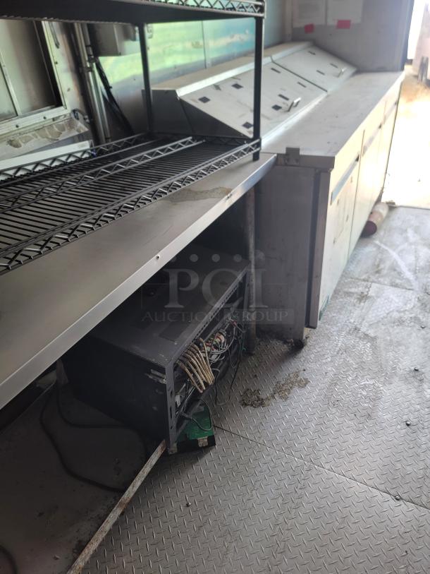 2019 Diamond Cargo 8.5x24 mobile kitchen interior, showing shelves, storage, and wiring. Needs cleaning.