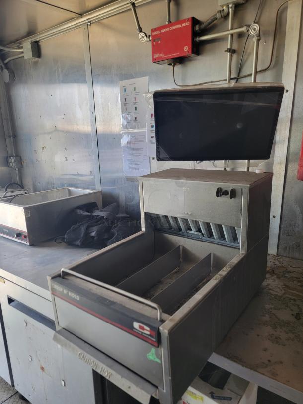 Interior of 2019 Diamond Cargo 8.5x24 mobile kitchen featuring commercial fryers and griddle. Needs cleaning.
