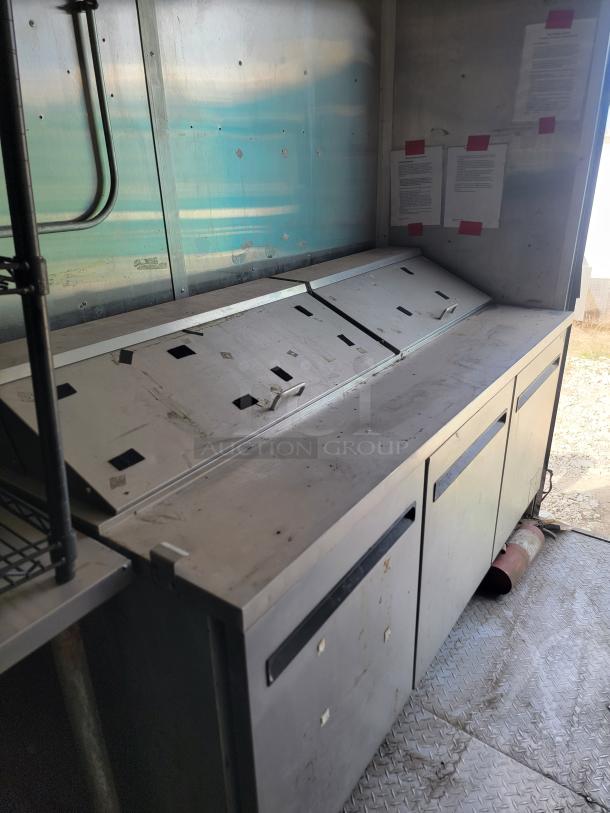 Interior view of a 2019 Diamond Cargo 8.5x24 mobile kitchen with visible stainless steel storage counters, showing signs of needed cleaning.