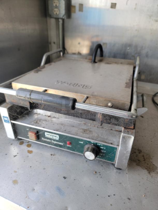 Waring Tostato Supremo commercial sandwich grill with visible wear, needs cleaning. Handles and knobs intact.