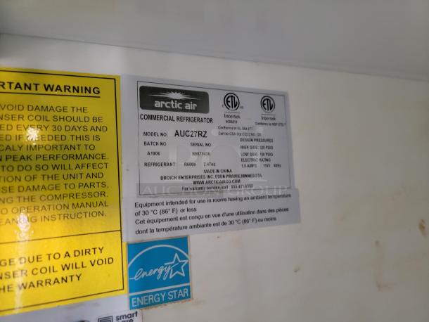 Label inside the Diamond Cargo mobile kitchen showing Arctic Air model AUC27RZ commercial refrigerator specs.