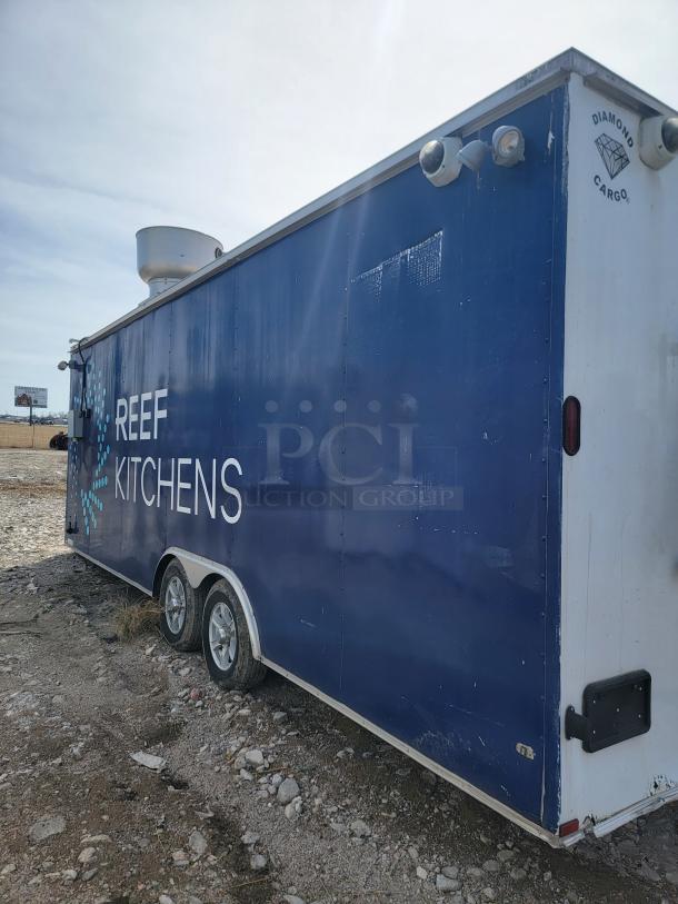 2019 Diamond Cargo 24' mobile kitchen trailer, blue exterior, tandem axle, branded "REEF KITCHENS," vent hood on roof.