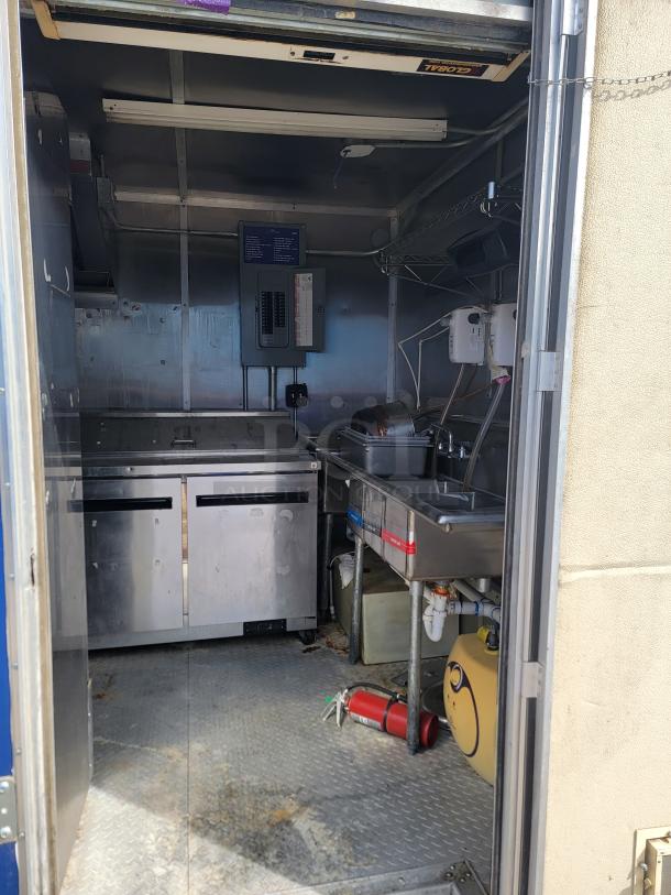 2019 Diamond Cargo 24' mobile ghost kitchen interior with Arctic Air refrigeration, Vulcan appliances, sink, and vent hood.
