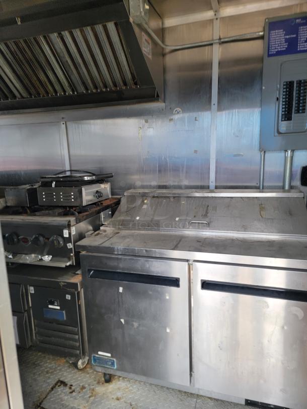 2019 Diamond Cargo 24' mobile kitchen interior with Arctic Air fridge, Vulcan griddle, commercial vent hood, in used condition.