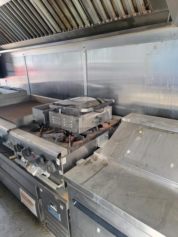 2019 Diamond Cargo mobile kitchen interior with Vulcan burners, Chef's Supreme panini press, and vent hood. Used condition.