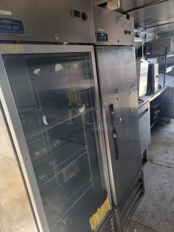 2019 Diamond Cargo 24' mobile kitchen interior featuring Arctic Air refrigerator and freezer; commercial-grade appliances visible.