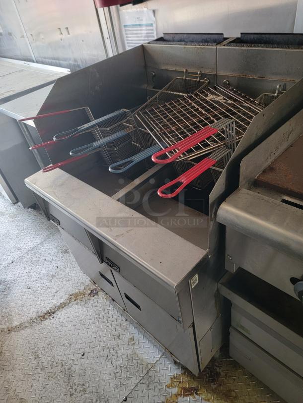 2019 Diamond Cargo 24' mobile kitchen interior with fryers, griddles, and storage, showcasing a fully equipped professional setup.