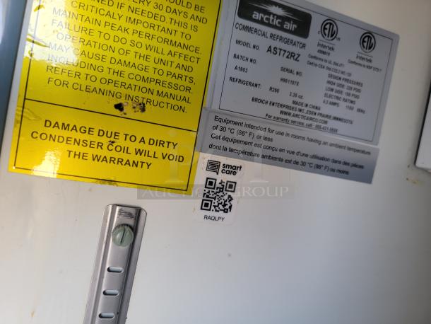 Close-up of Arctic Air commercial refrigerator label, model AST72R, with warranty warning and QR code.