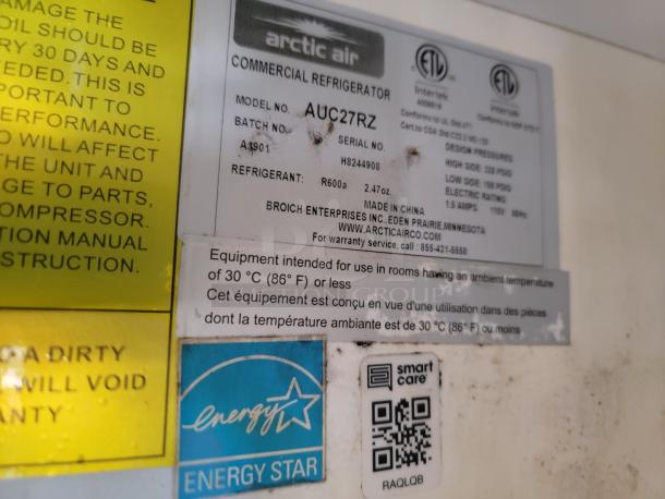 Close-up of Arctic Air refrigeration unit label on 2019 Diamond Cargo 24' mobile kitchen. Describes model AUC27RZ specifications, energy ratings, and usage guidelines.