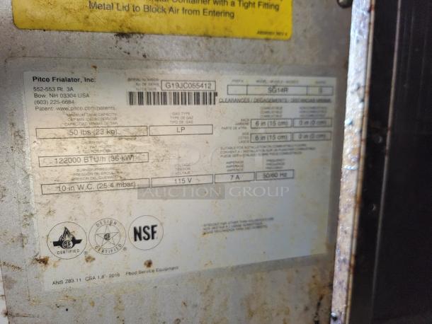 Label with Pitco Frialator model SG14R details, including gas type, BTU rating, and NSF certification, on a worn metal surface.