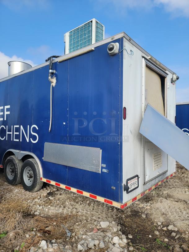 2019 Diamond Cargo 24' mobile kitchen trailer with dual axles, showing exterior damage. Heavy-duty, high-capacity model.