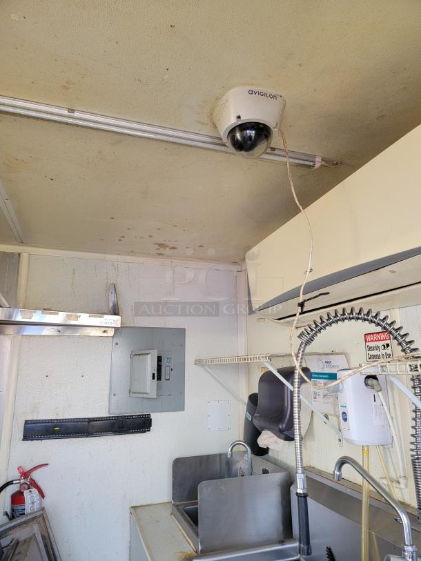 Interior of 2019 Diamond Cargo 24' Mobile Kitchen with Avigilon security camera, dual sinks, climate control, and Serv-Ware equipment.