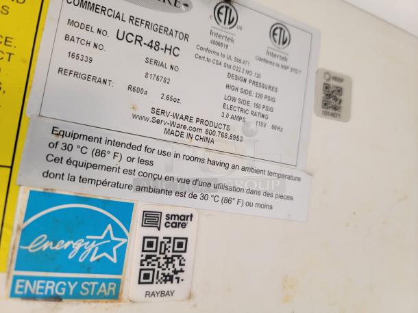 Label on Serv-Ware UCR-48-HC commercial refrigerator. Shows model, serial, refrigerant R600a, Energy Star, and usage info.