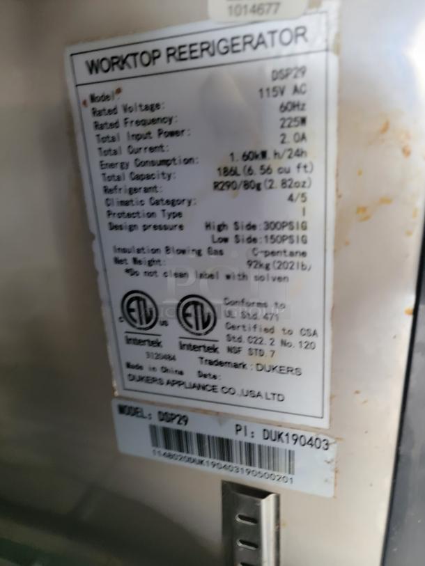 Label inside 2019 Diamond Cargo trailer showing Dukers DSP29 worktop refrigerator specs: 115V, 60Hz, 225M input, R290 refrigerant.