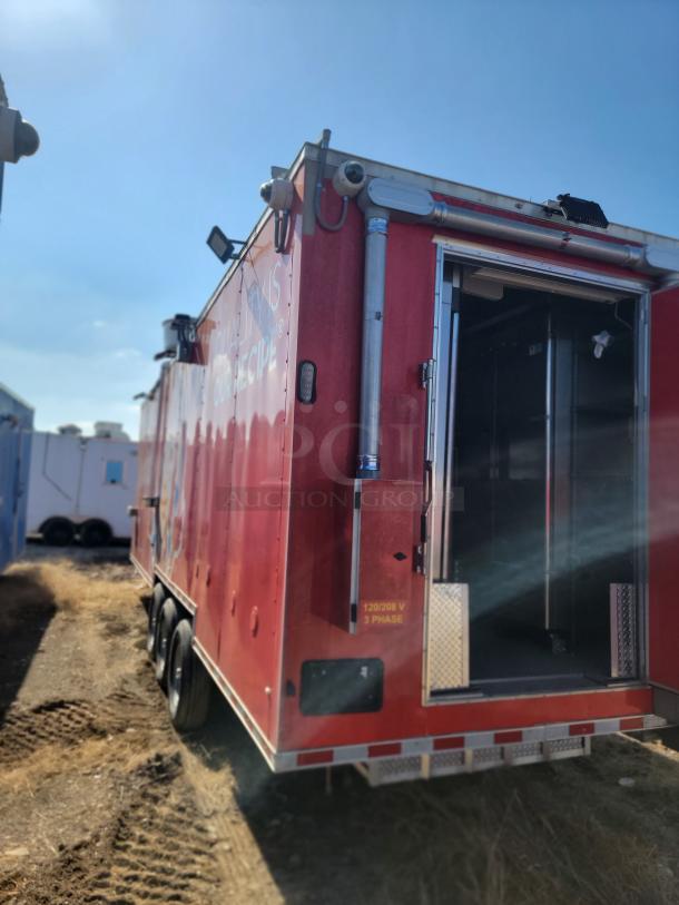 2022 Rock Solid Cargo 28' mobile kitchen trailer, red exterior, triple-axle, 120/208V 3-phase electric system visible on side.