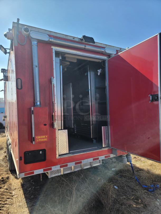 2022 Rock Solid Cargo 28' mobile kitchen trailer, red exterior, open rear door showing interior with commercial-grade equipment.