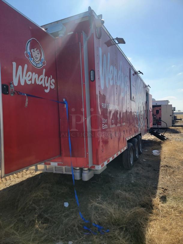 2022 Rock Solid Cargo 28' Wendy’s mobile kitchen trailer, triple-axle, red branding, commercial-grade setup, high-capacity.