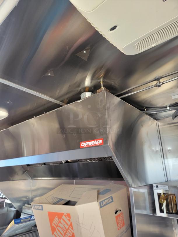 2022 Rock Solid Cargo 28' mobile kitchen interior with CaptiveAire ventilation. Commercial-grade setup, robust condition.