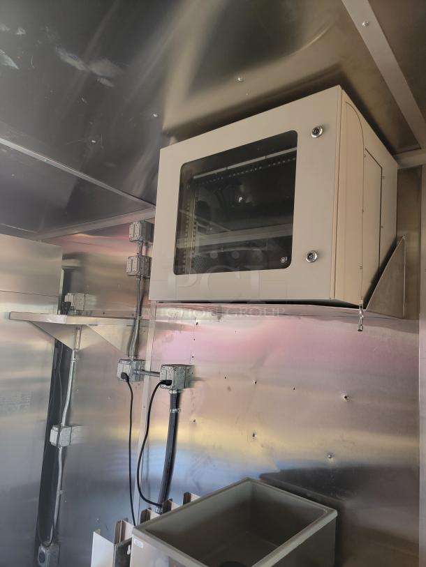 2022 Rock Solid Cargo 28' mobile kitchen interior with commercial-grade electrical setup, robust for high-capacity culinary use.