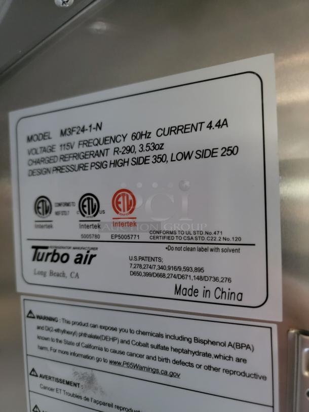 Close-up of Turbo Air model label indicating M3F24-1-N, 115V, 60Hz, 4.4A. Features refrigerant details and safety warnings. Made in China.