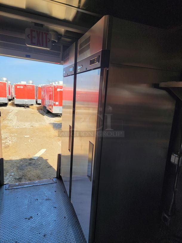 2022 Rock Solid Cargo 28' mobile kitchen interior with stainless steel appliances, ready for high-volume food service.