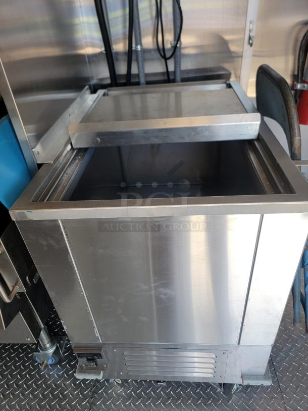 Stainless steel commercial cooler in a 2022 Rock Solid Cargo 28' mobile kitchen. Features durable construction, ideal for high-capacity use.