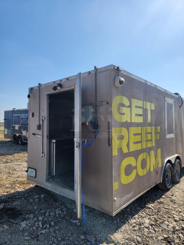 2019 Peach Cargo 24' mobile kitchen trailer, side view. Features include dual axles, partially open door, and exterior branding.