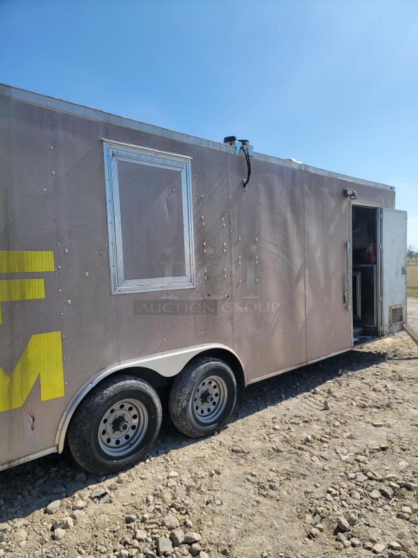 2019 Peach Cargo 24' mobile kitchen trailer, weathered exterior, dual axle, venting, open side door, ready for customization.