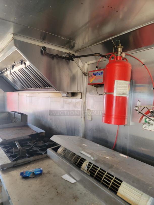 2019 Peach Cargo 24' mobile kitchen interior with stainless steel appliances, range, hood, and ProTexII fire suppression system.