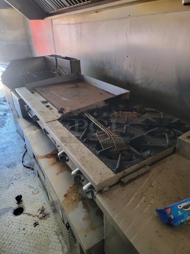 2019 Peach Cargo 24' mobile kitchen interior with stove, grill, fryer, and stainless steel surfaces; visible wear.