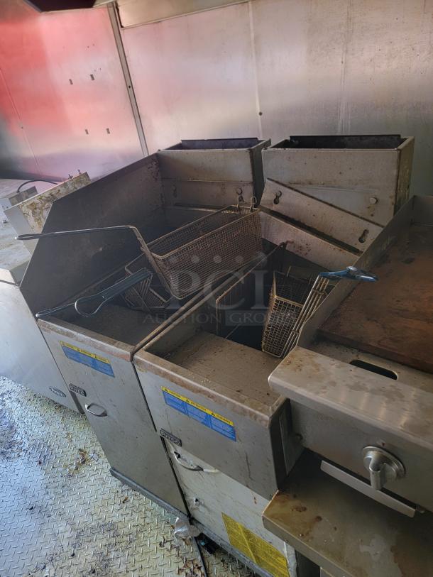 2019 Peach Cargo 24' mobile kitchen interior showing commercial fryers and storage cabinets, in used condition.