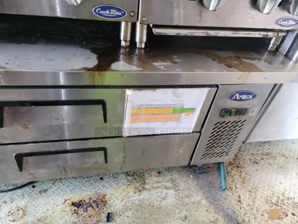 CookRite and Atosa kitchen equipment in a 2019 Peach Cargo 24' mobile kitchen. Visible signs of use, with labels on the unit.