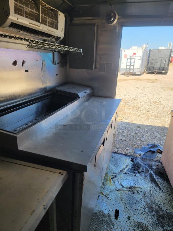 2019 Peach Cargo 24' mobile kitchen interior, featuring stainless steel counters, storage, and an air conditioning unit.