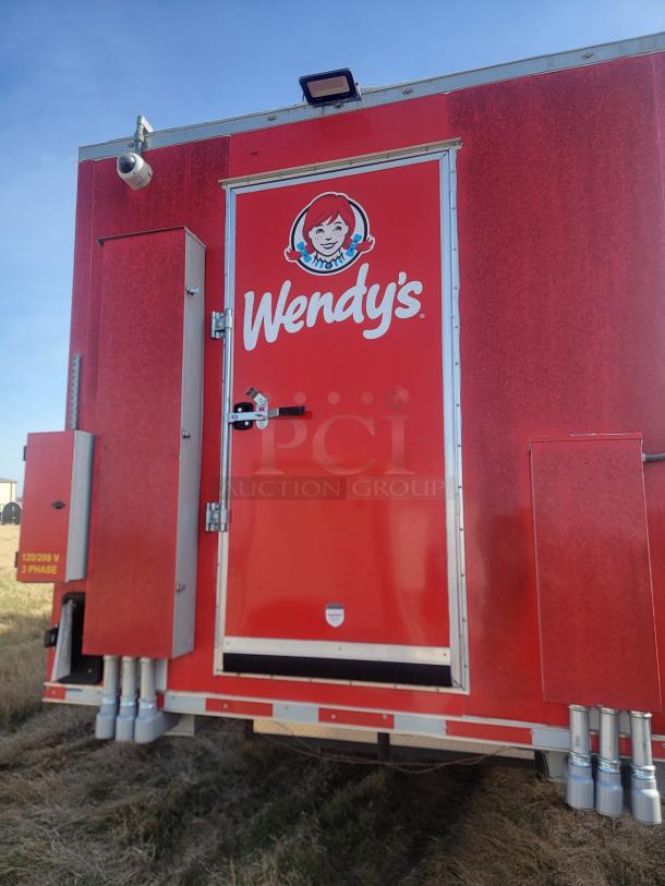 2021 Titanium Cargo 28' Triple Axle Mobile Kitchen, red exterior with logos, equipped with commercial kitchen appliances.