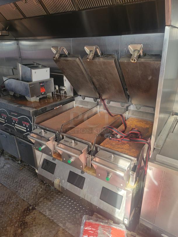 2021 Titanium Cargo 28' Mobile Kitchen interior with Garland grills, Henny Penny fryers, and Menumaster ovens.