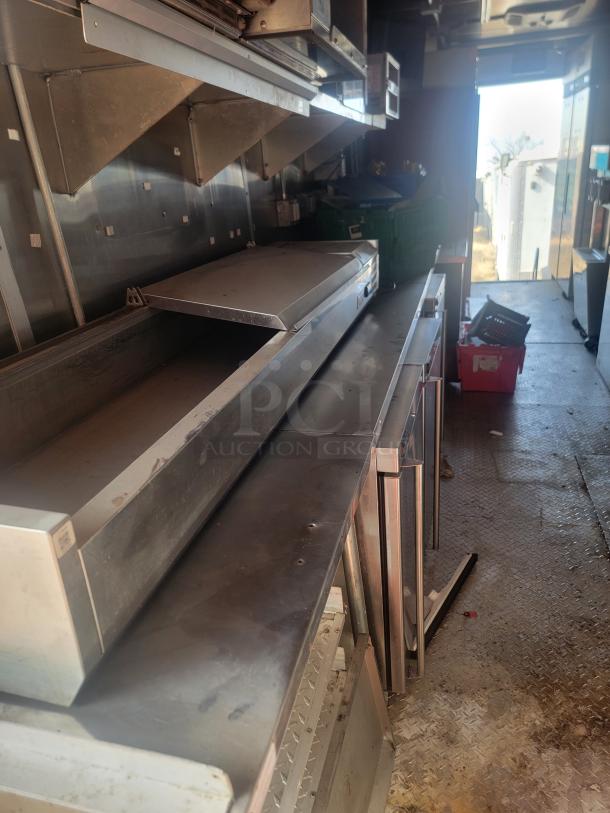 2021 Titanium Cargo 28' Triple Axle Mobile Kitchen interior, featuring stainless steel countertops and commercial equipment.