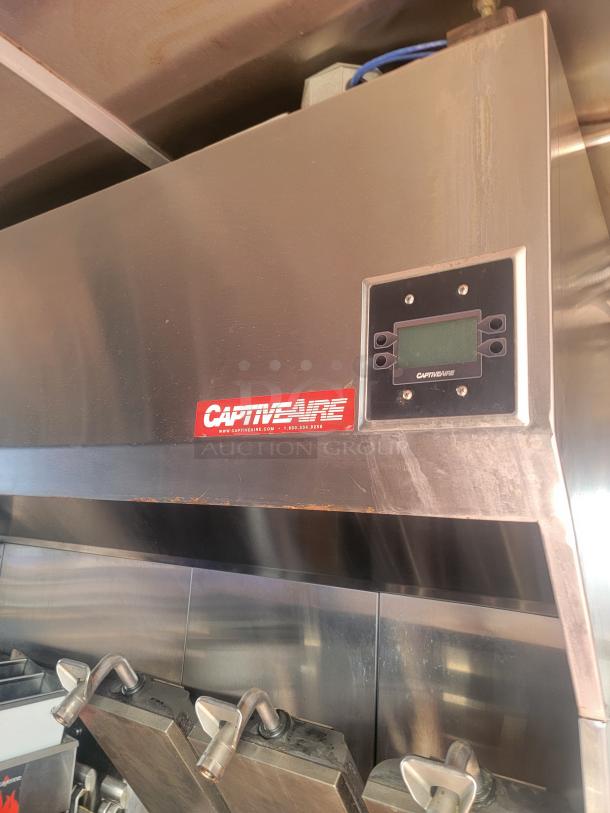 CaptiveAire stainless steel ventilation unit inside mobile kitchen, featuring control panel and piping.